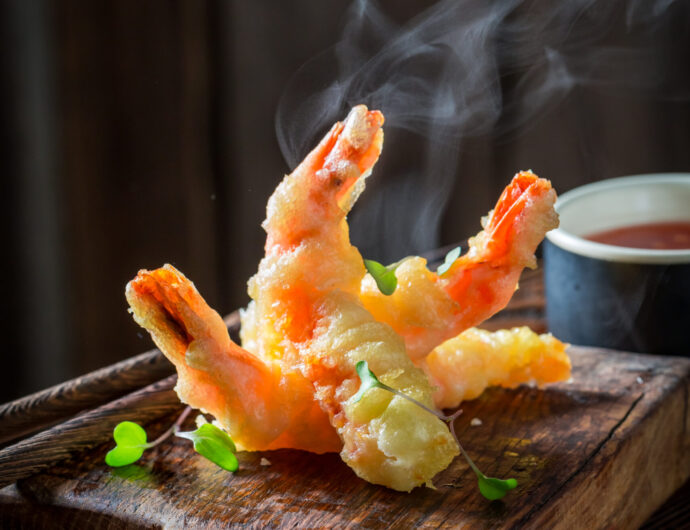 Closeup of shrimp in tempura with sour sauce and sweet