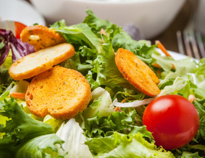 Mixed salad in white bowl. Selective focus.
