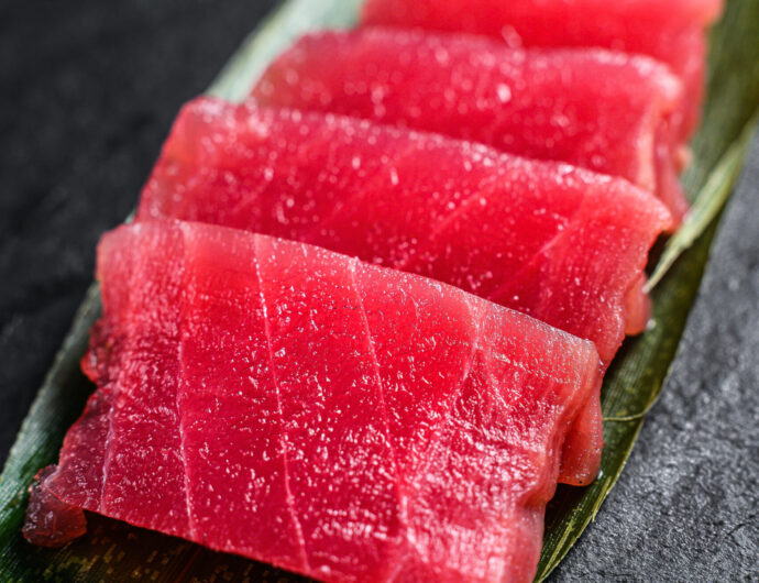 sashimi tuna on a stone Board. Black background. Top view. Close up.