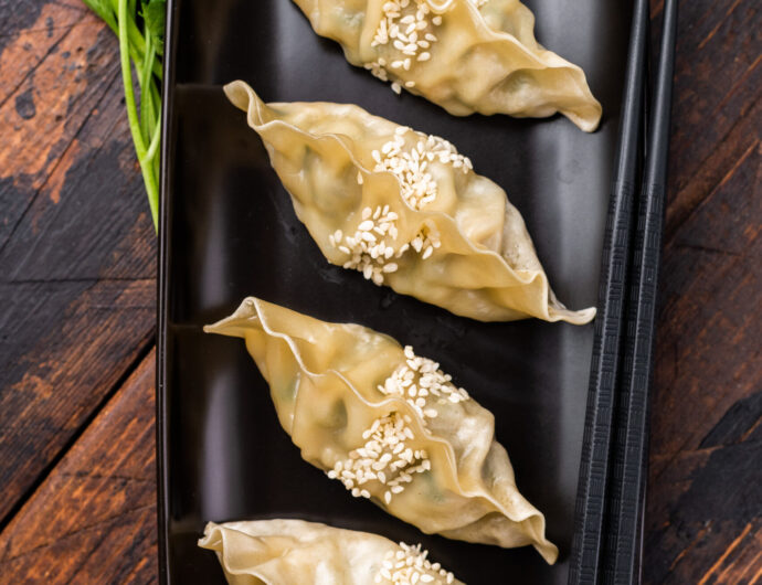 Steamed Korean Dumplings with pork meat and vegetables. wooden background. top view.