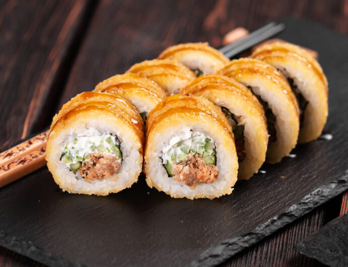 Sushi roll with smoked eel and salmon with cucumber and cheese. Traditional delicious fresh sushi roll set. Sushi menu. Japanese cuisine restaurant. Asian food.